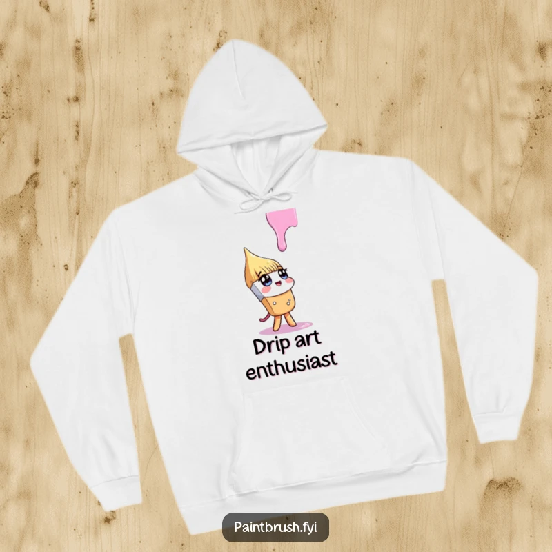 Funny hoodie depicting a paintbrush character looking up curiously at a falling paint drip, embodying the spirit of artistic inquiry.
