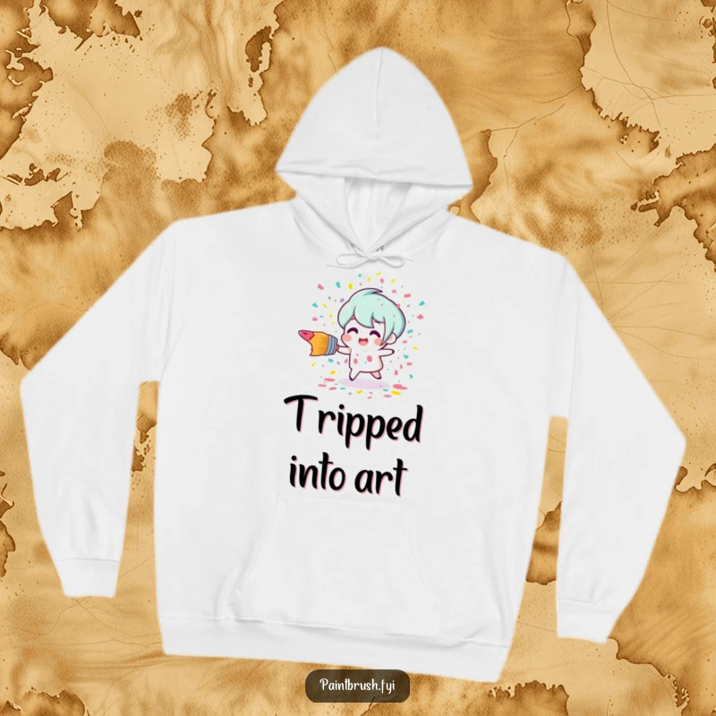 Funny tripping paintbrush character creating a burst of colorful paint confetti on a cozy, humorous hoodie.