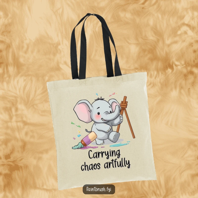 Funny tote bag showing a clumsy elephant tripping over a large paintbrush, causing a comical splash of paint, great for art supplies.