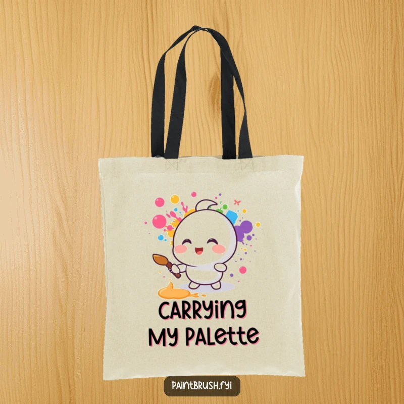 Funny tote bag showcasing a small round character joyfully splattering rainbow colors with a paintbrush, ideal for carrying art and smiles.